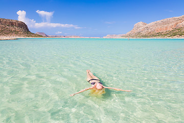 Image showing Caucasian lady floating in turquoise sea.