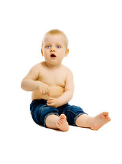 Image showing baby sitting on the floor. Studio. isolated