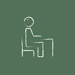 Image showing Student sitting on a chair in front of the desk icon drawn chalk.