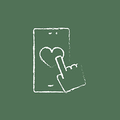 Image showing Smartphone with heart sign icon drawn in chalk.