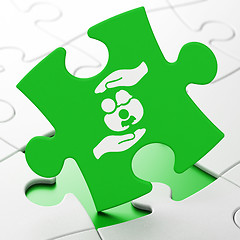 Image showing Insurance concept: Family And Palm on puzzle background