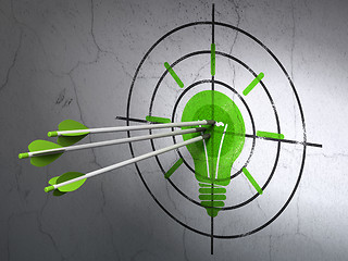 Image showing Finance concept: arrows in Light Bulb target on wall background