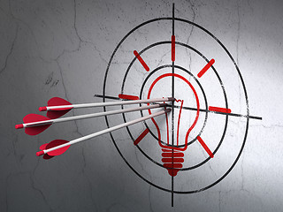 Image showing Finance concept: arrows in Light Bulb target on wall background