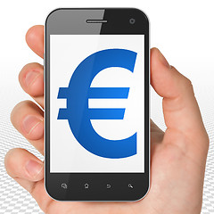 Image showing Currency concept: Hand Holding Smartphone with Euro on display