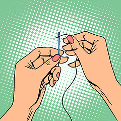 Image showing Needlework seamstress threads the needle