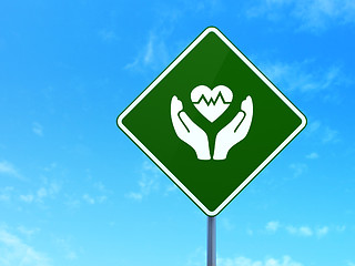 Image showing Insurance concept: Heart And Palm on road sign background