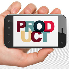 Image showing Marketing concept: Hand Holding Smartphone with Product on  display