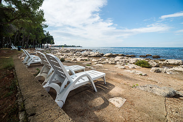 Image showing loungers on the rocky beach