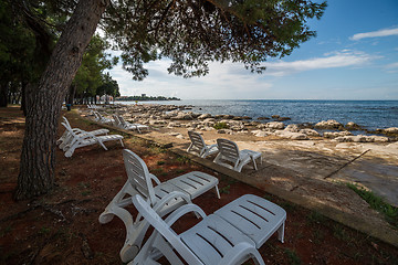 Image showing loungers on the rocky beach