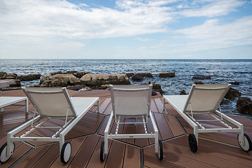 Image showing loungers on the rocky beach