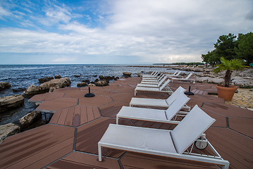 Image showing loungers on the rocky beach