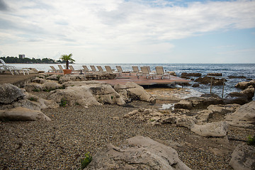 Image showing loungers on the rocky beach