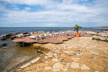 Image showing loungers on the rocky beach