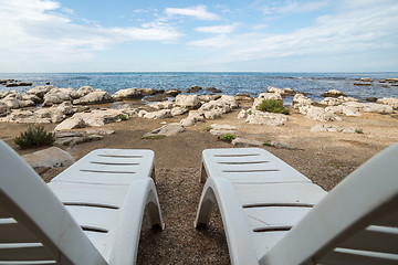 Image showing loungers on the rocky beach