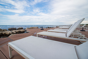 Image showing loungers on the rocky beach