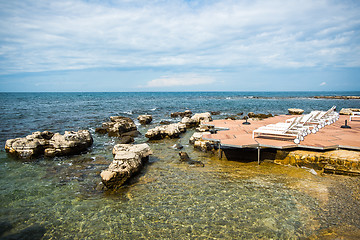 Image showing loungers on the rocky beach