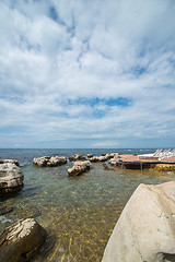 Image showing loungers on the rocky beach