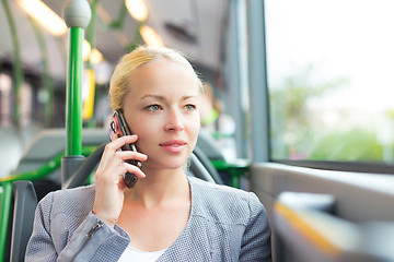 Image showing Blonde business woman traveling by bus.