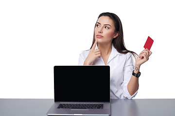 Image showing Business woman with laptop showing credit card