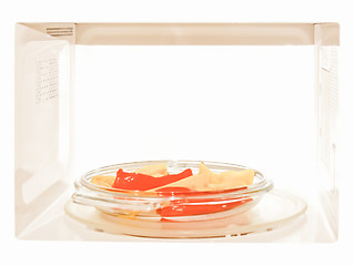 Image showing Retro looking Microwave with peppers