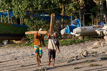 Image showing Men transports cargo from ship to shipyard