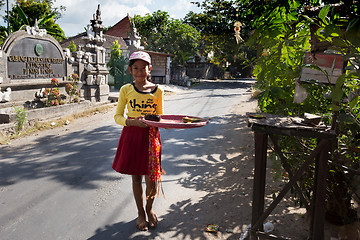 Image showing indonesian girl bring offerings to the home temple