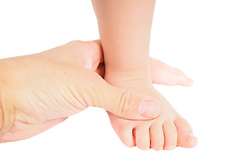 Image showing Male hand holding firmly around a foot of toddler isolated on wh
