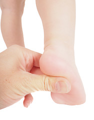 Image showing Male hand holding firmly pressing with thumb under foot of toddl