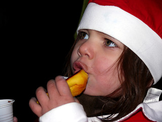 Image showing Cristmas girl eating bun!