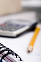 Image showing pencil and calculator on notebook