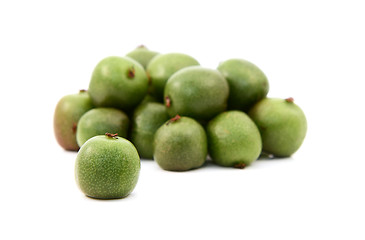 Image showing Kiwi berry against heap of green berries