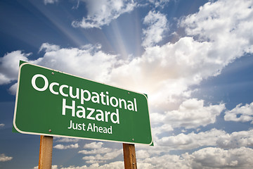 Image showing Occupational Hazard Green Road Sign Over Clouds