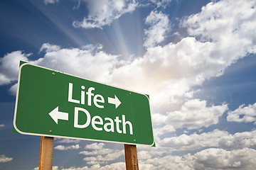 Image showing Life and Death Green Road Sign Over Clouds