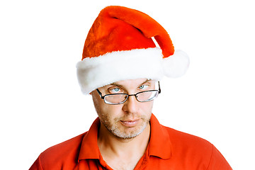 Image showing Unshaven slanting eyes Man in Santa hat. Isolated on white. Humo