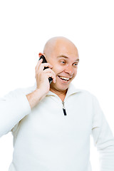 Image showing Bald man emotionally communicates by phone. Isolated. Studio