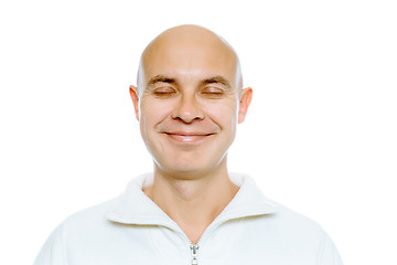 Image showing Bald smiling man with his eyes closed. Isolated. Studio