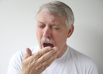 Image showing senior man getting ready to yawn or sneeze 