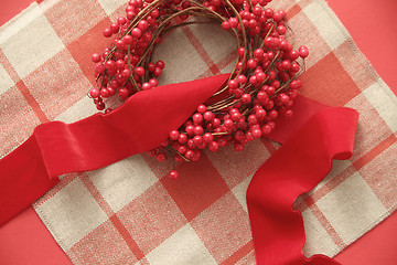 Image showing Christmas berries and ribbon on plaid