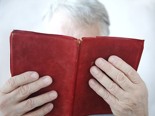 Image showing older man reading a book