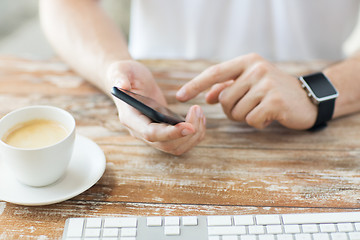 Image showing close up of hands with smart phone and watch