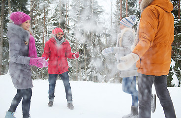 Image showing happy friends playing with snow in winter forest
