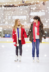 Image showing happy girls friends on skating rink