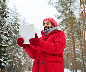 Image showing happy man with tablet pc in winter forest