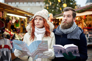 Image showing happy couple with map and city guide in old town