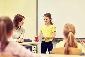 Image showing group of school kids with teacher in classroom