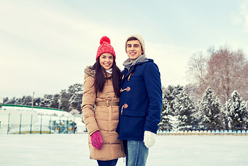 Image showing happy couple ice skating on rink outdoors