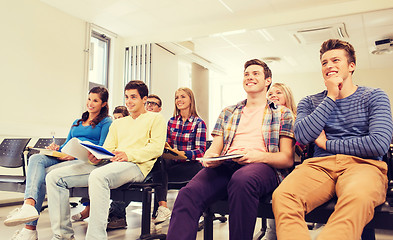 Image showing group of smiling students in lecture hall