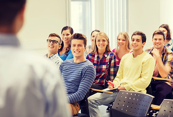 Image showing group of students and teacher with notebook