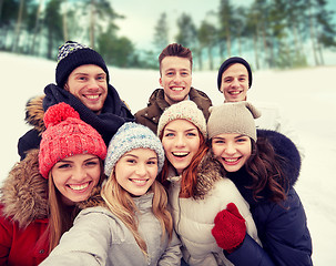 Image showing group of smiling friends taking selfie outdoors