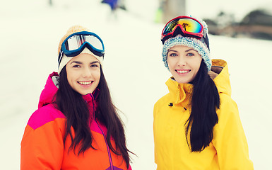 Image showing happy girl friends in ski goggles outdoors